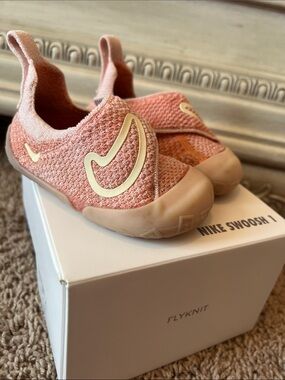 Nike Kids Peach Pink Flyknit Slip-On Sneakers with Gold Swoosh 1